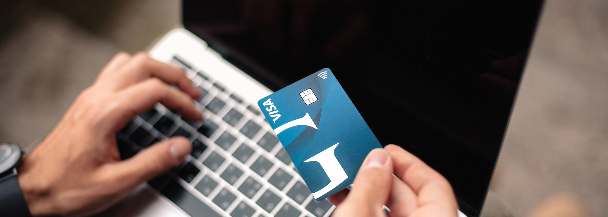 E-Statements Splash image: Woman holding coffee using a laptop with Guardian Bank Login